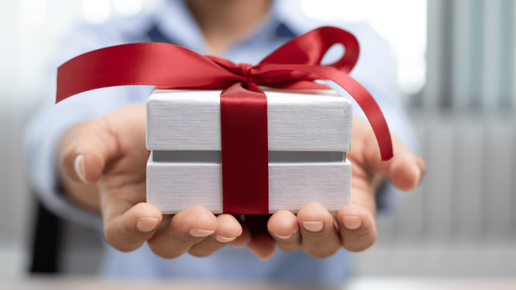 A person holding a gift box to the camera